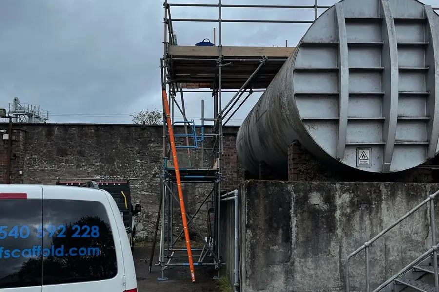 M.F Scaffold liveried van beside a scaffold access tower built to a large industrial storage tank